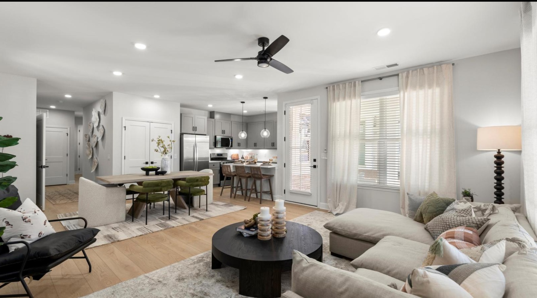 a living room with a large table and chairs