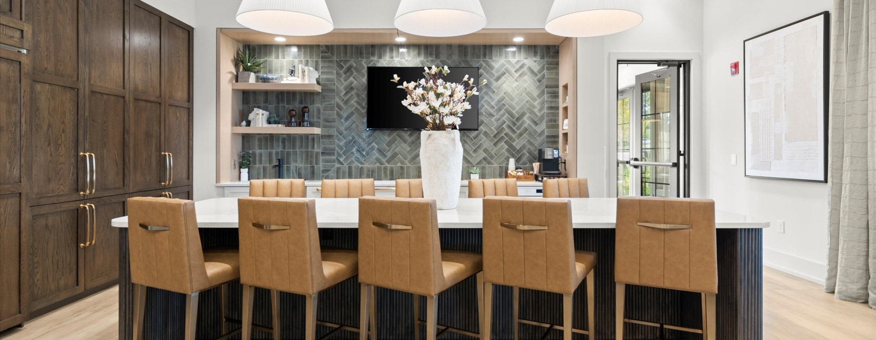 a spacious well-lit resident kitchen with a large island