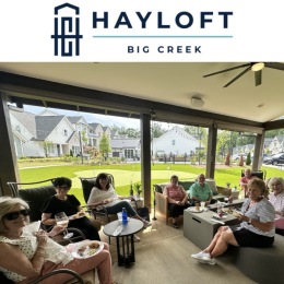 a group of people relaxing and eating outdoors