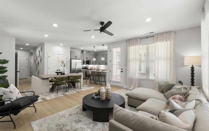 a living room with a large table and chairs